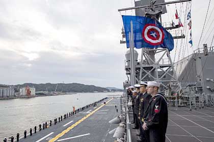 SASEBO, Japan (Dec. 6, 2019) Sailors man the rails as the America-class  amphibious assault ship USS America (LHA 6) arrives at Sasebo, Japan to join the forward deployed naval forces. America is assigned to Amphibious Squadron Eleven and will serve as the flagship for Expeditionary Strike Group 7 while conducting routine operations in the Western Pacific.  U.S. Navy photo by MC3 Vincent E. Zline
