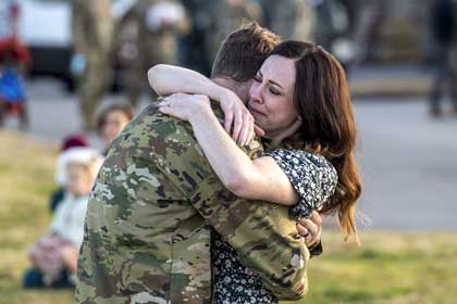 Air Force Capt. Brian Vaughn, 61st Airlift Squadron pilot, reunites with his wife upon returning to Little Rock Air Force Base, Ark., Dec. 8, 2021, following a deployment supporting contingency operations in East Africa. Photo by Air Force Senior Airman Aaron Irvin